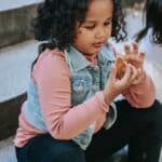 Black girl having gingerbread treat with friend