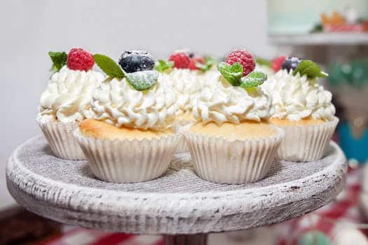 Cupcakes with cream and berries with mint