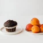 Fresh ripe apricots served on table with chocolate muffin