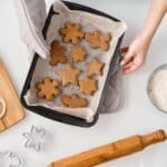 Person Holding a Tray With Different Shapes of Brown Cookies