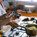 Person Taking a Picture of Cooking Spaghetti