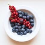 Ripe appetizing berries in ceramic bowl