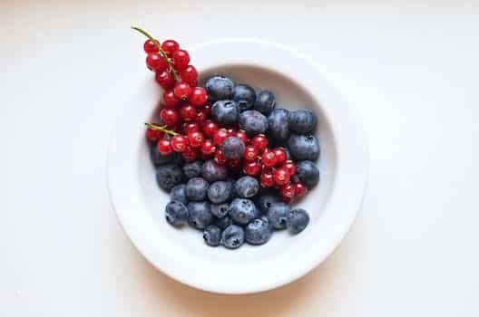 Ripe appetizing berries in ceramic bowl