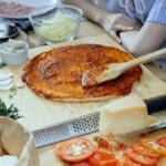 Women in process of preparing homemade pizza