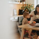 A Mother Baking while Caring for Her Kid