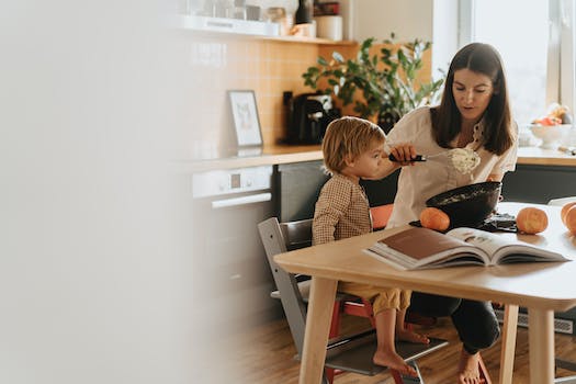 A Mother Baking while Caring for Her Kid