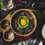 Healthy east dish served on wooden cutting board in cafe