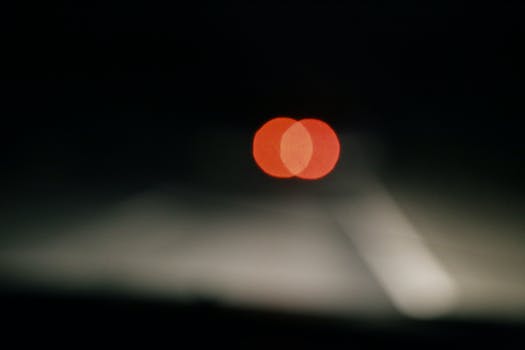 Stop light of automobile on road at night