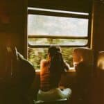 Unrecognizable woman riding train and looking out window