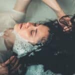 Woman Lying in Bathtub Filled With Water