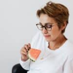 Optimistic female with piece of ripe watermelon