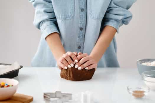 Person Kneading a Chocolate Dough by Hands