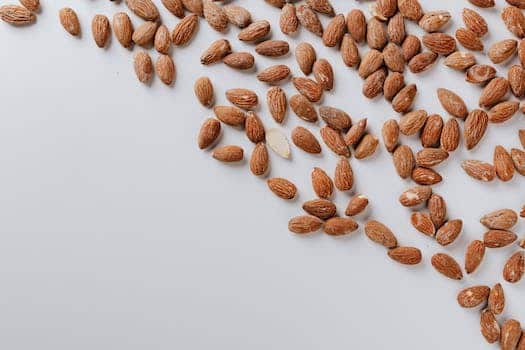 Top view of delicious and nutrition almond cluttered on white table illustrating healthy food eating concept