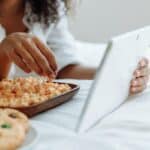 Woman Watching on a Digital Tablet with Snacks