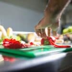 A Person Slicing Peppers