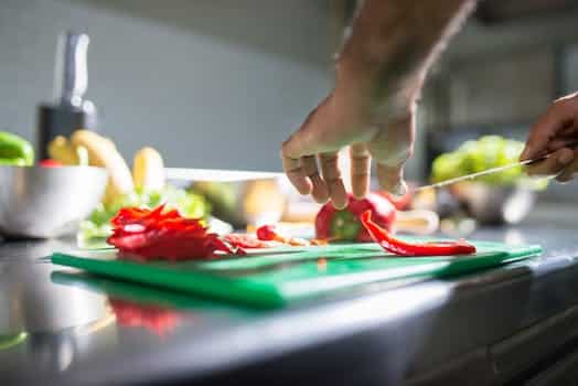 A Person Slicing Peppers