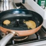 Eggs frying in pan on stove