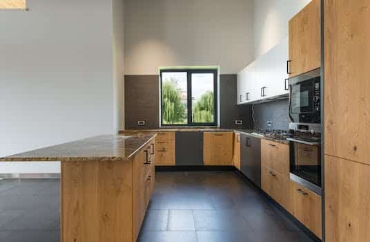 Interior of modern kitchen with wooden furniture