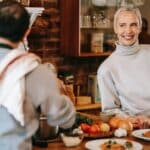 Man cooking dinner on counter near woman in kitchen