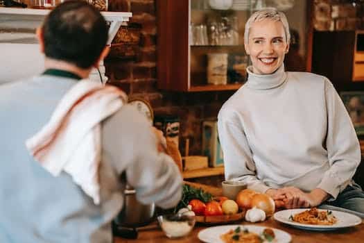 Man cooking dinner on counter near woman in kitchen