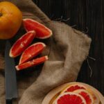 Sliced Orange Fruit on Brown Textile