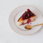 Tasty cheesecake on plate with spoon