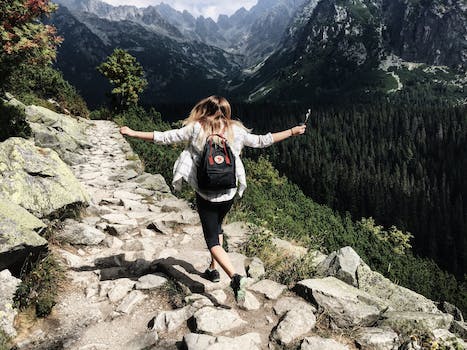 Woman Standing on Cliff