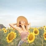 Woman Standing on Sunflower Field