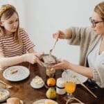 A Mather and Daughter Having Breakfast