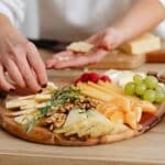 A Person Preparing a Charcuterie Board