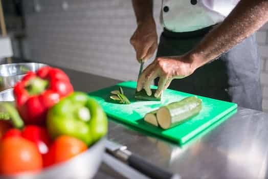 A Person Slicing a Cucumber