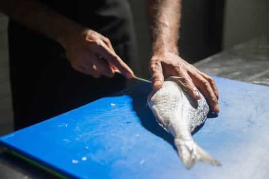 A Person Slicing a Fish