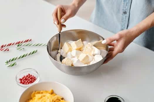 Person Holding Stainless Steel Bowl With Marshmallows