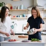 Woman in White Button Up Shirt Holding White Ceramic Plate