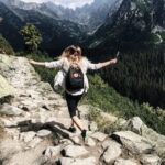 Woman Standing on Cliff