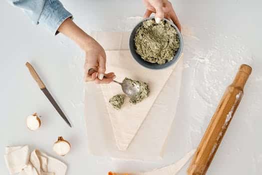 Person Making a Christmas Tree Shaped Bread With Fillings