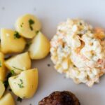 Boiled potatoes near traditional Russian salad