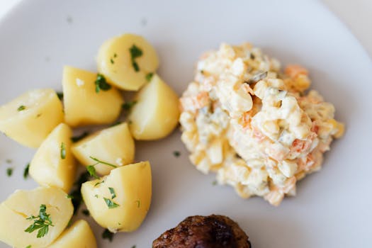 Boiled potatoes near traditional Russian salad